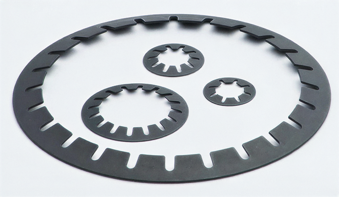Four slotted disc springs in different sizes for preloading ball bearings